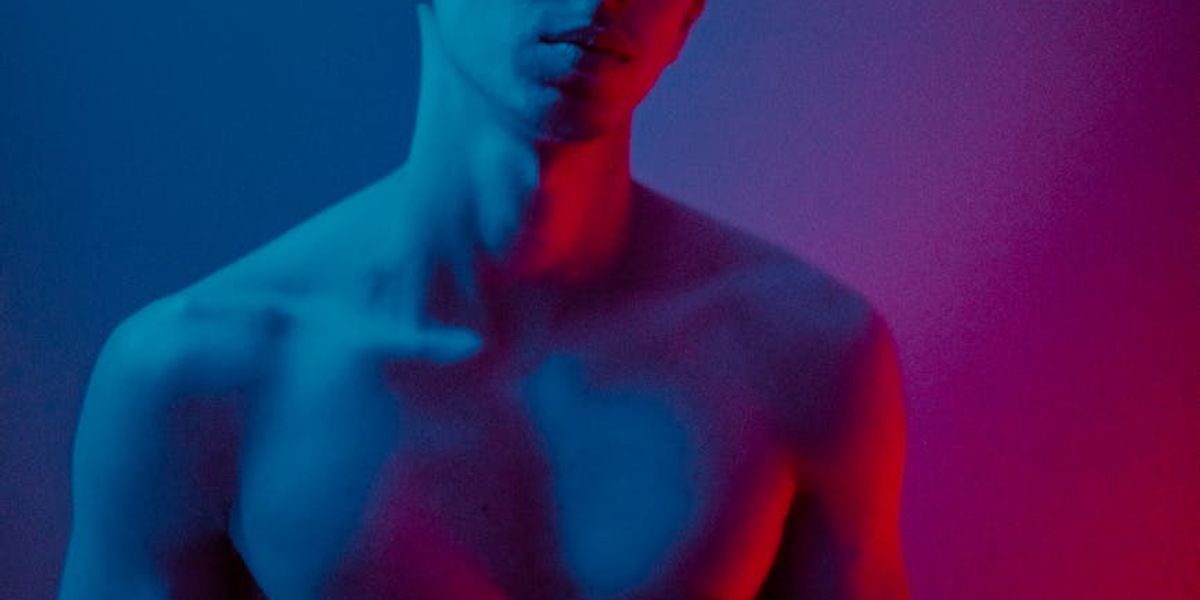 Wide shot of a minimalist fitness studio with neon lights.